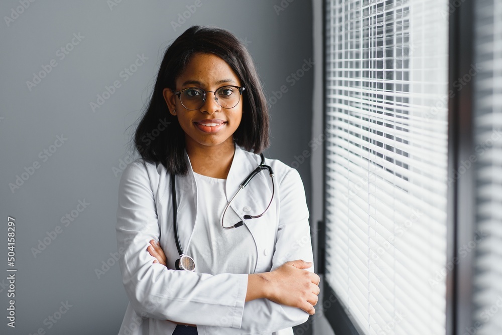 Smiling young adult indian female doctor wear white coat in medical ...