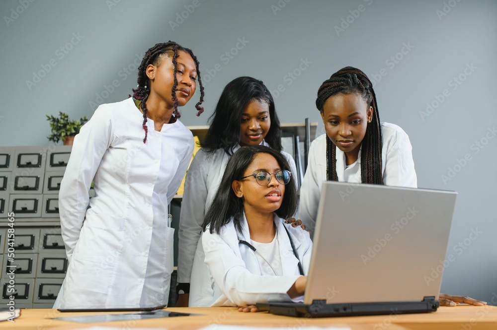 Group Of Medical Staff Meeting Around Table In Hospital. Group Of Medical Staff Meeting Around Table In Hospital.
