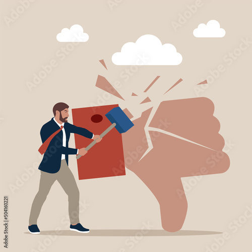 Businessman holding hammer hitting dislike thumb down mark with cracks.