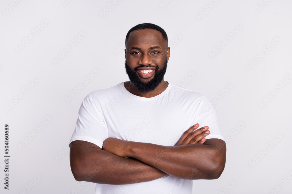 Photo of charming attractive guy dressed casual t-shirt arms crossed smiling isolated white color background Photo of charming attractive guy dressed casual t-shirt arms crossed smiling isolated white color background