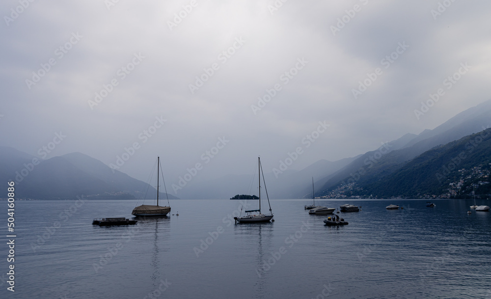 Boats on a calm lake cloudy skies