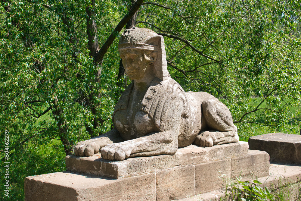 A bridge with sphinx statue. Veltrusy chateau. Czech Republic.