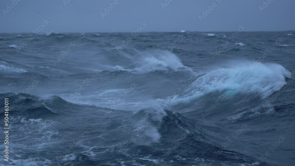 Storm. High waves. White foam on wind. Side view low on water. Wind breaks waves. Splashes Storm. High waves. White foam on wind. Side view low on water. Wind breaks waves. Splashes