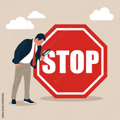 Businessman with magnifying monitor and investigate incident with exclamation stop sign. Incident management, root cause analysis or solving problem, identify risk or critical failure concept.