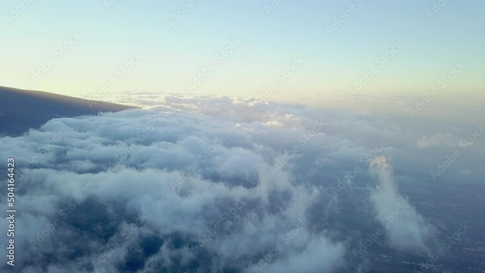 The aerial view of the thick white clouds in the sky in Tenerife Spain with the view of the volcano El Teide.geology shot The aerial view of the thick white clouds in the sky in Tenerife Spain with the view of the volcano El Teide.geology shot