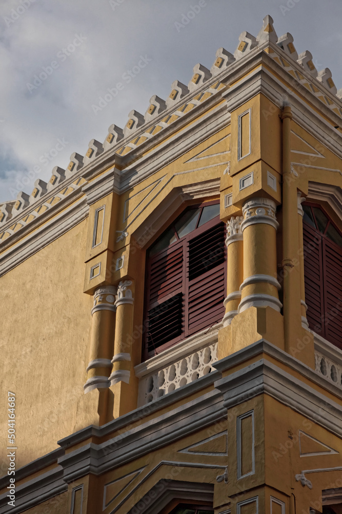 Fototapeta premium A yellow old building under a blue sky