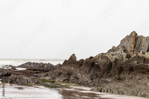 rocks on the beaches of sopelana in the cantabrian sea a cloudy day