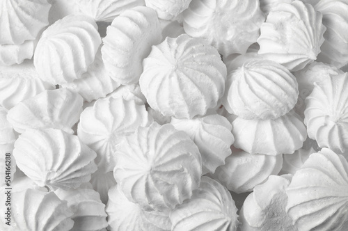 background, texture of a large number of French dessert meringue cakes.