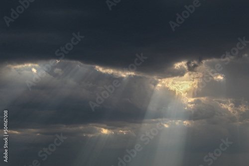 the sun shines through the clouds
