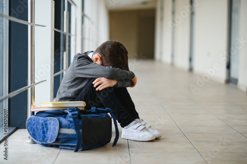 Canvas Print schoolboy crying in the yard of the school, negative emotion