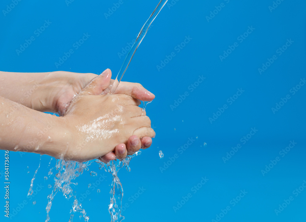 Washing hands with water on blue background Washing hands with water on blue background