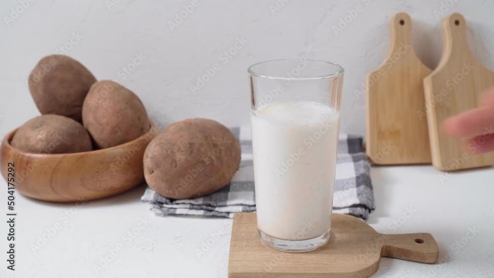 Glass with potato milk to the potato. Trend in healthy eating. Alternative food. Healthy Vegetable Milk. Glass with potato milk to the potato. Trend in healthy eating. Alternative food. Healthy Vegetable Milk.