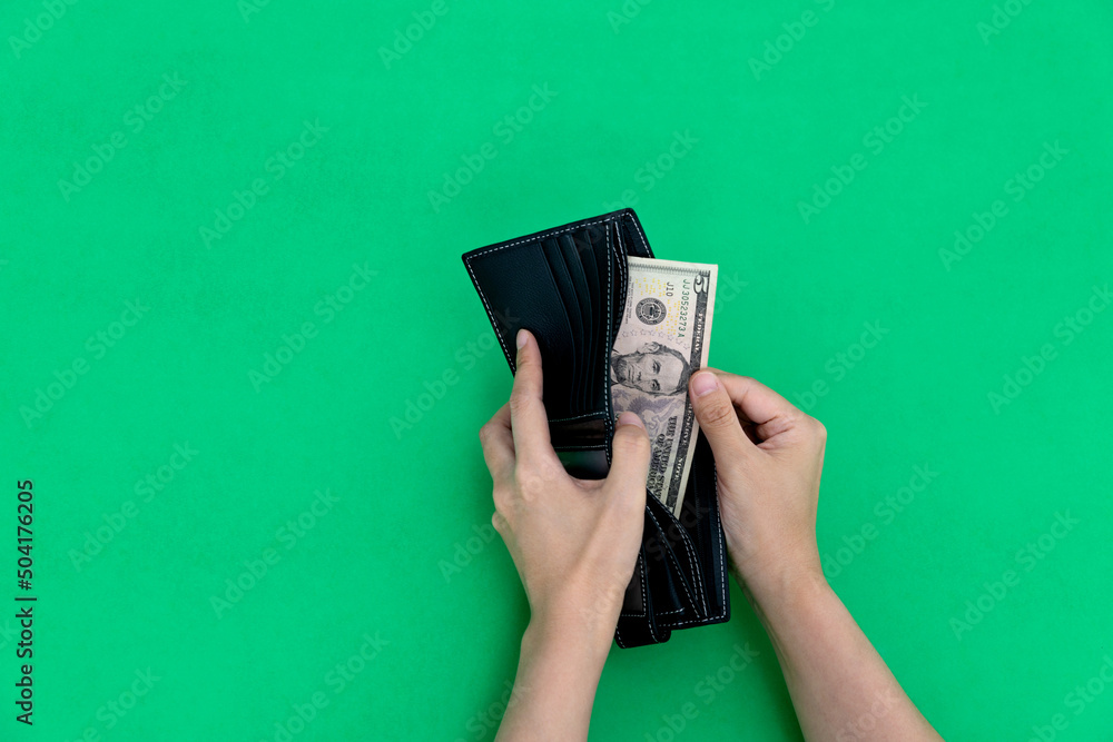Woman hand holding a leather wallet with dollar - obrazy, fototapety, plakaty 