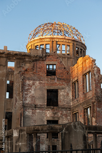 The last rays of the setting sun reflect upon the canopy of the Atomic Bomb dome in Hiroshima, Japan. photo