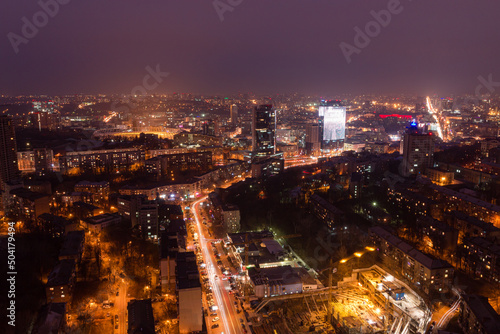 Ukraine  Kyiv     March 12  2016  Aerial panoramic view on central part of Kyiv city from a roof of a high-rise building. Night life in a big city. Foggy and rainy weather. 