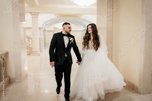 Beautiful wedding couple. Happy bride and luxurious husband. marble staircase