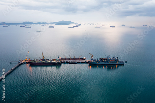 Ship with oil tanker , floating Storage Unit for import export petroleum gas LPG and CNG at evening rainstrom background aerial view .