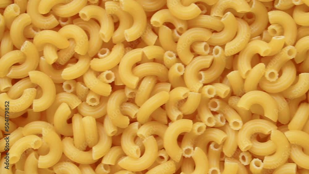 Full screen uncooked raw elbow macaroni Full screen uncooked raw elbow macaroni