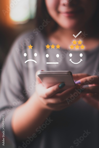 woman using smart phone Customer satisfaction concept with smile icon photo