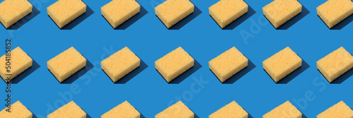 фотографія Banner background, pattern with yellow dishcloth on blue background