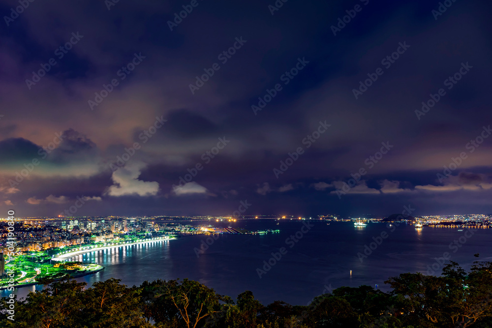 Night view of Rio de Janeiro downtown, Guanabara bay, Santos Dumont airport, Flamengo beach and the streets and buildings of city illuminateds