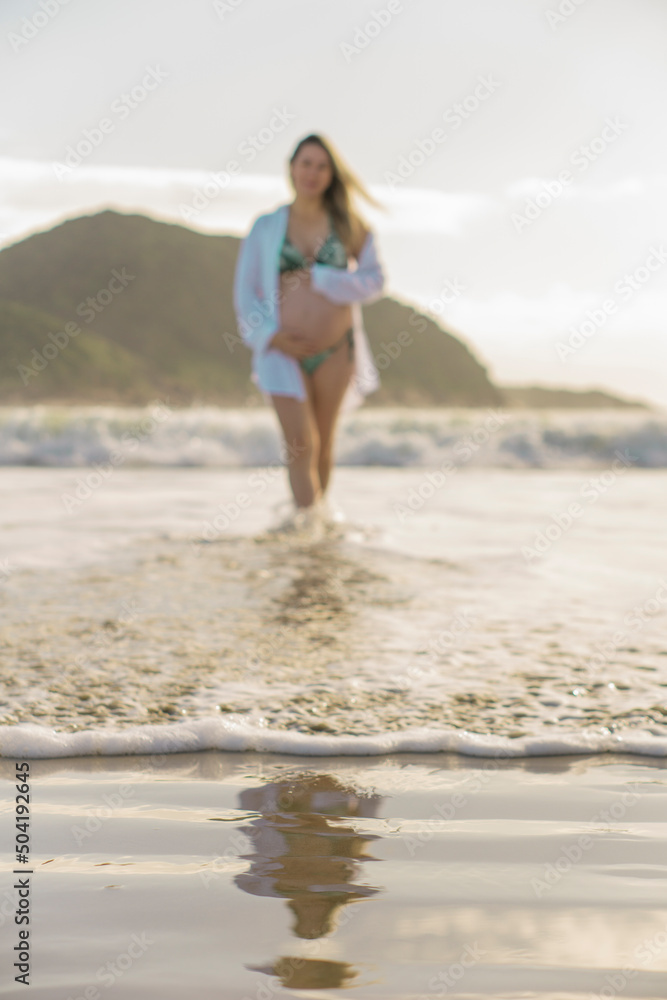 pregnant woman walking by the sea pregnant woman walking by the sea
