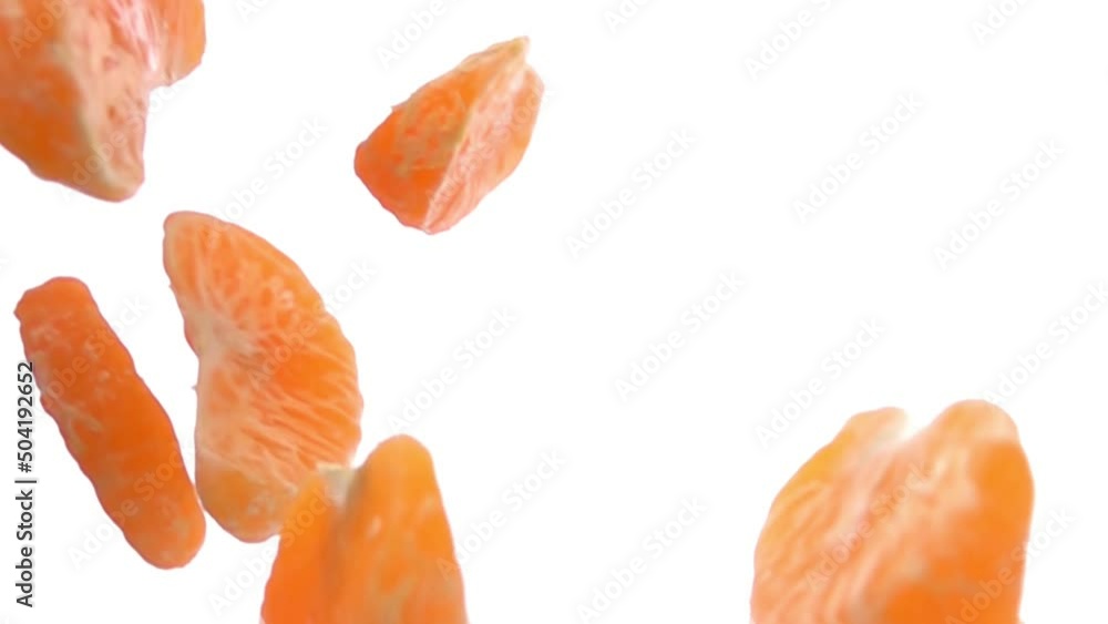 Close-up of the peeled tangerine pieces falling and rotating on white background Close-up of the peeled tangerine pieces falling and rotating on white background
