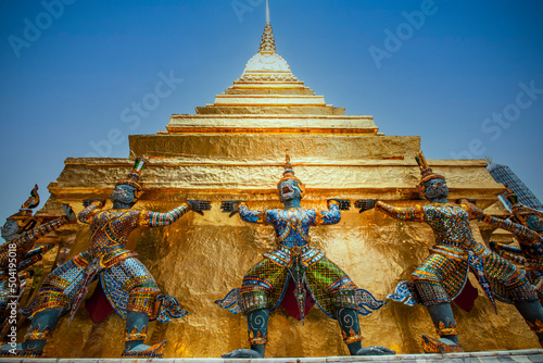 Wallpaper Mural Close up giant statue at the base of Gold pagoda in Wat Phra Kaew (Temple of Emerald Buddha) in Royal Grand palace, Bangkok, Thailand