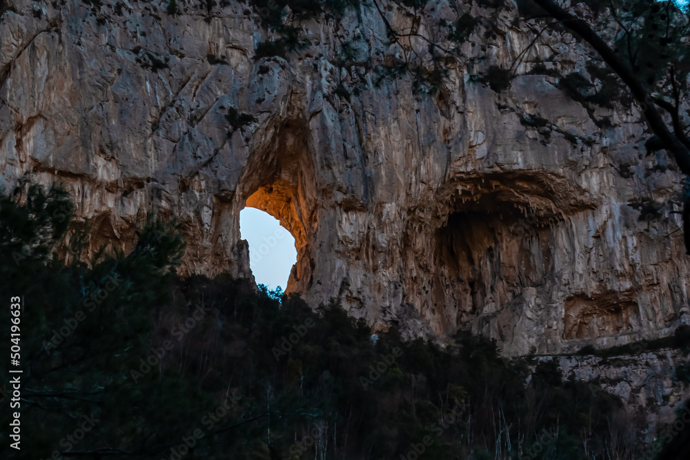 Scenic view on rock formation Montepertuso Il Buco on hiking trail Path of Gods between Positano and Praiano, Amalfi Coast, Campania, Italy, Europe. Hole in a cliff rock at the Mediterranean Sea