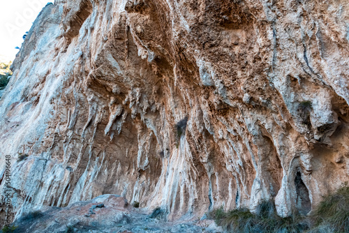 The karst calcareous rock formation of the the steep cliff above the coastal town Positano, Amalfi Coast, Italy, Campania, Europe. Geostructural carbonate rocks in Apennine mountains. Path of the Gods
