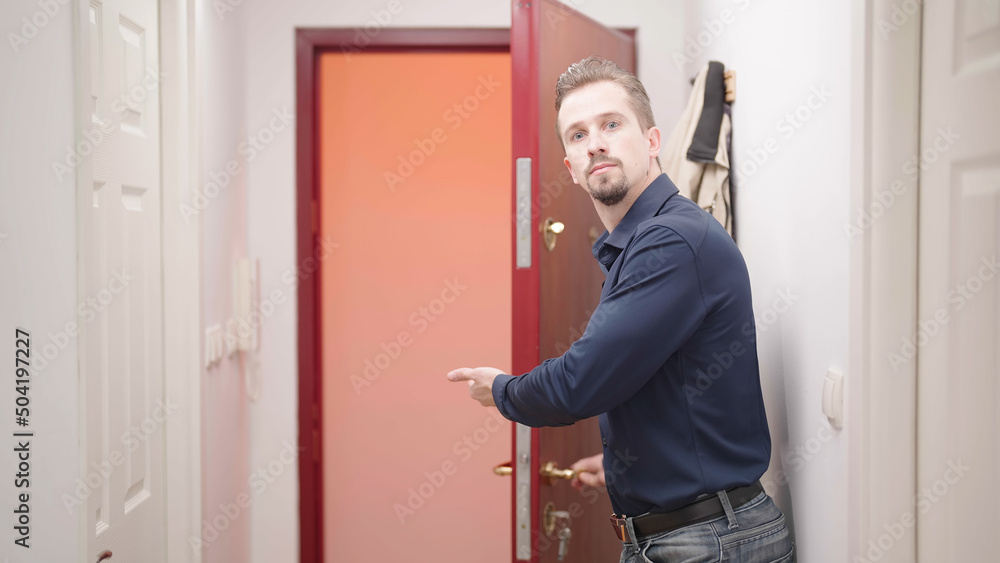 Attractive man open door and show way out with strict gesture Attractive man open door and show way out with strict gesture