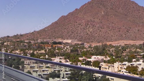 Walking on a balcony towards Camelback Mountain Scottsdale Arizona while zooming out with the lens. photo