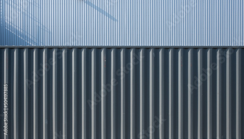 Shipping container and corrugated iron sheet  aluminum Facade of a warehouse as background texture