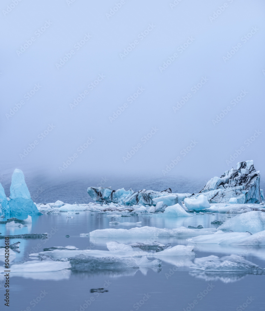 Massive Icebergs on Jokulsarlon lagoon in Iceland under clear white sky