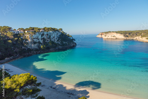 Aguas transparentes y turquesas de la playa de Cala Galdana, en Menorca. Islas Baleares. photo