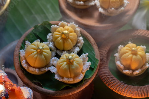 Close up view of several Thai traditional desserts served  on banana leaves