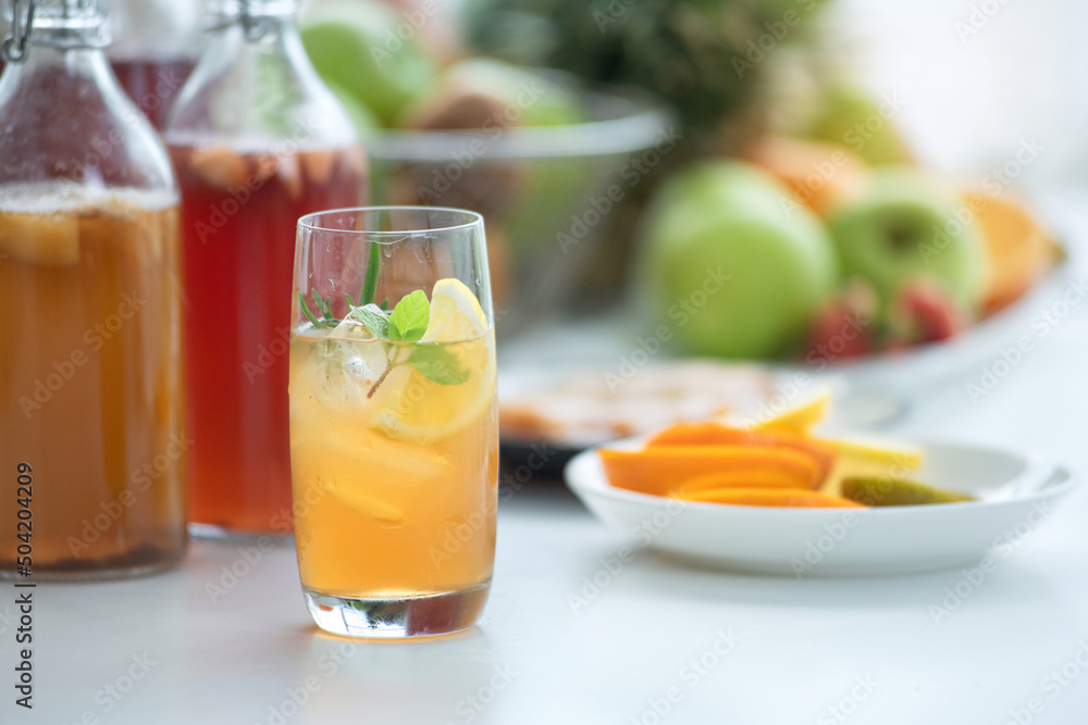 Homemade fermented raw Kombucha tea, healthy natural probiotic flavored drink, glass of Kombucha drink with lemon on white background Homemade fermented raw Kombucha tea, healthy natural probiotic flavored drink, glass of Kombucha drink with lemon on white background