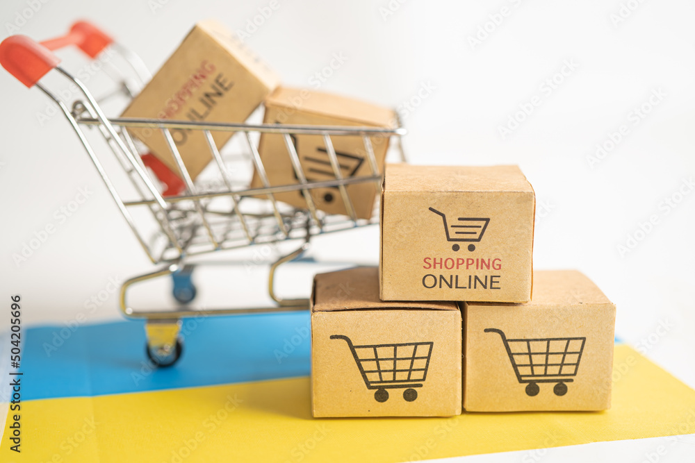 Box with shopping online cart logo and Ukraine flag, Import Export Shopping online or commerce finance delivery service store product shipping, trade, supplier concept.