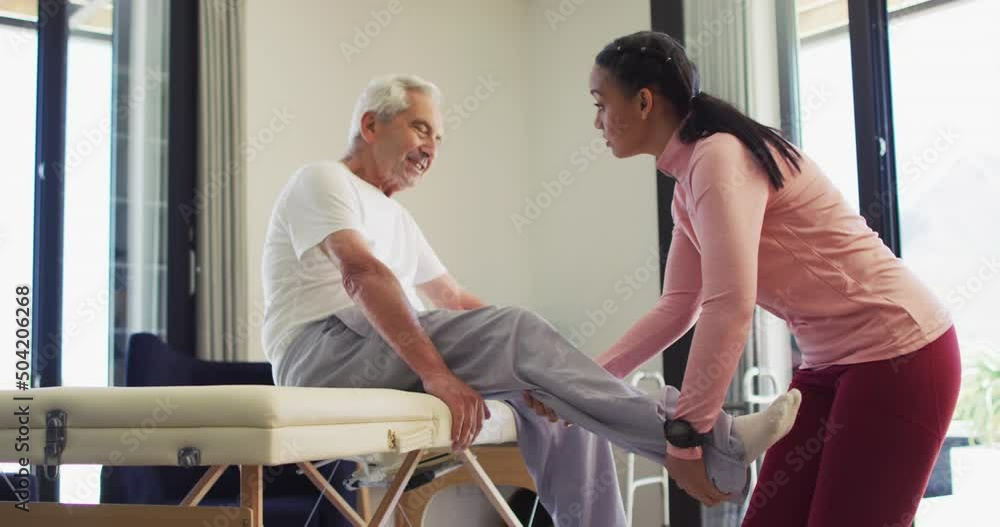 Video of biracial female physiotherapist examining caucasian senior man Video of biracial female physiotherapist examining caucasian senior man