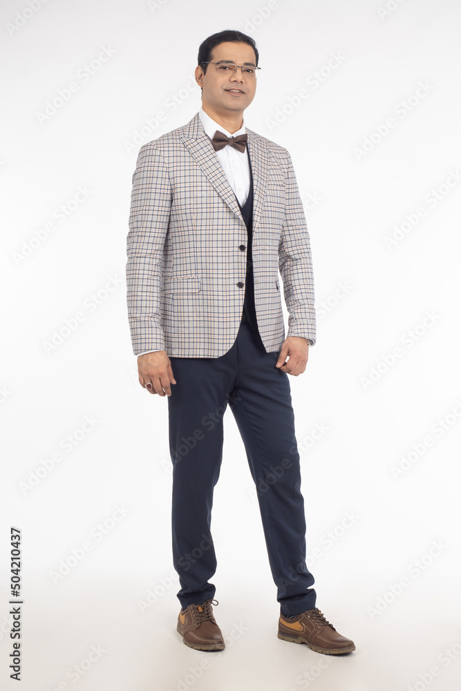Man in business suit. Young man in plaid jacket. Guy in suit stands to his full height. Man is dressed in business style. Guy businessman in glasses. Businessman smiling isolated on white background. Man in business suit. Young man in plaid jacket. Guy in suit stands to his full height. Man is dressed in business style. Guy businessman in glasses. Businessman smiling isolated on white background.
