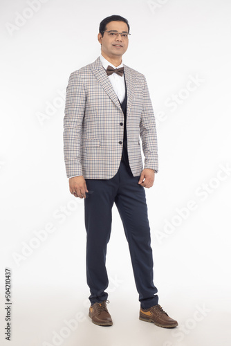 Man in business suit. Young man in plaid jacket. Guy in suit stands to his full height. Man is dressed in business style. Guy businessman in glasses. Businessman smiling isolated on white background.