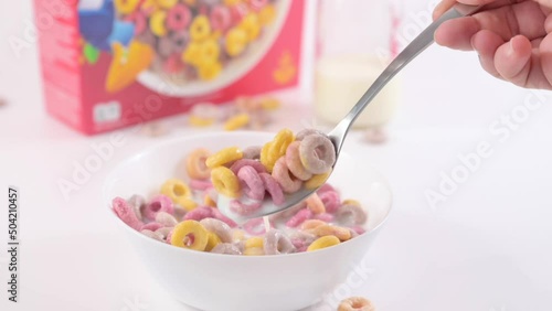 Dry breakfast Kelloggs froot loops in a bowl with milk. Multi-colored rings for children's breakfast. format for smartphones and social networks. slow motion. 05.10.2022 Bologna, Italy photo