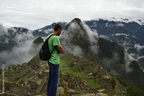 Fototapeta Naklejka Na Ścianę i Meble -  A man looks at the ruins of Machu Pichhu. Peru