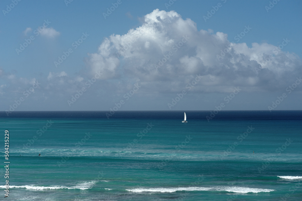 Ocean background with sky and clouds shown in Waikiki, Hawaii.