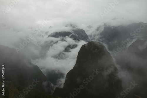 Ruins of the ancient Inca city machu picchu in fog, Peru