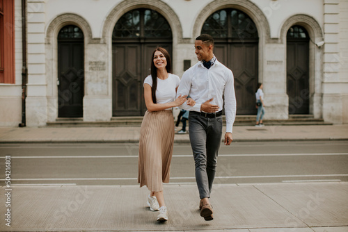 Young multiethnic couple walking on the street