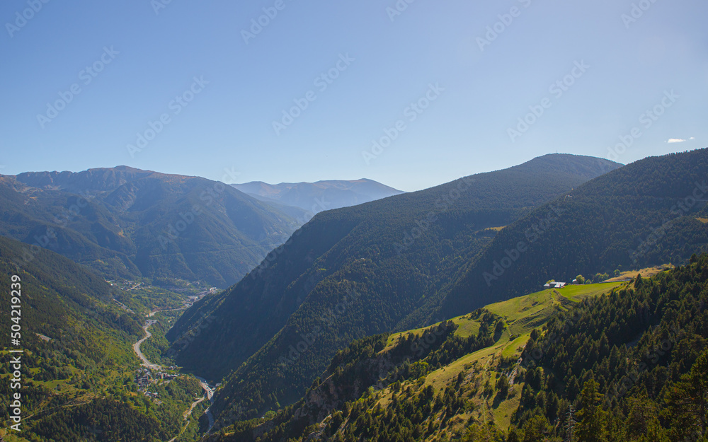 Beautiful nature landscape of green mountains and a clear blue sky during a sunny spring day in Andorra