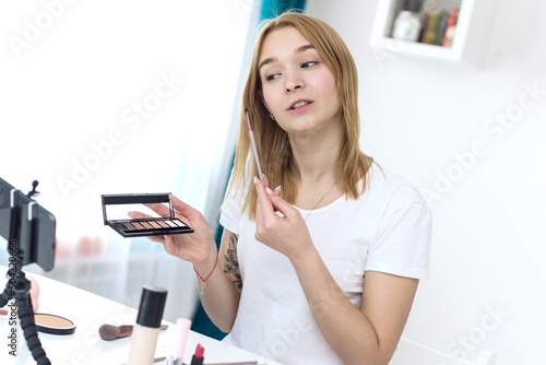Female video blogger showing how to apply cosmetics to her face. A great female influencer to talk about non-animal test cosetics