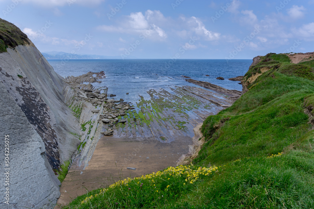 view of the Flysch rock formations and cliffs with tidal pools on the Basque Country coast near Zumaia