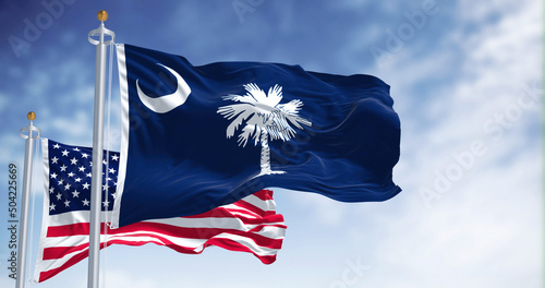 The South Carolina state flag waving along with the national flag of the United States of America